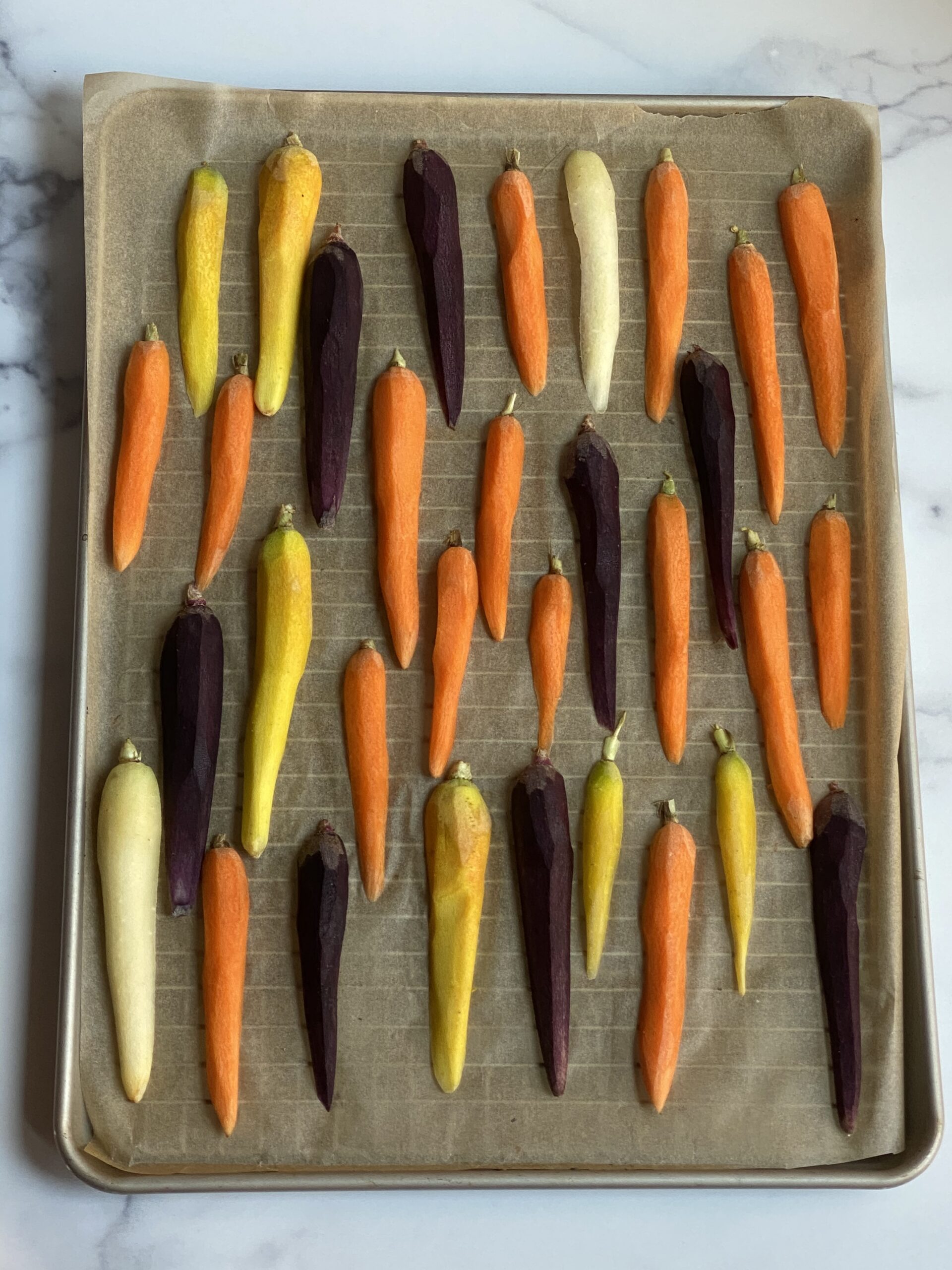 Carrots placed on a sheet in a single layer