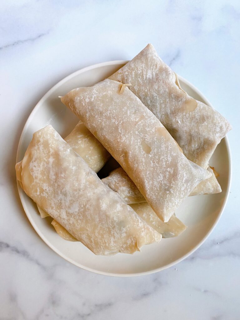 A plate full of uncooked Taco Egg Rolls