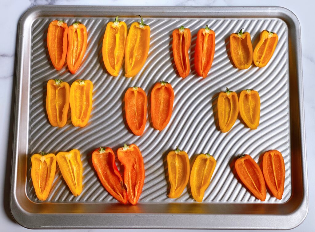 An Assortment of Sliced Mini Sweet Peppers on a Baking Sheet