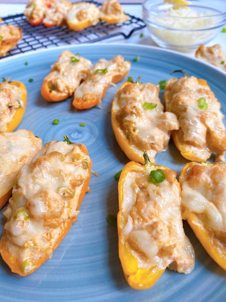Close up shot of Shrimp and Crab Stuffed Mini Sweet Peppers on a blue plate
