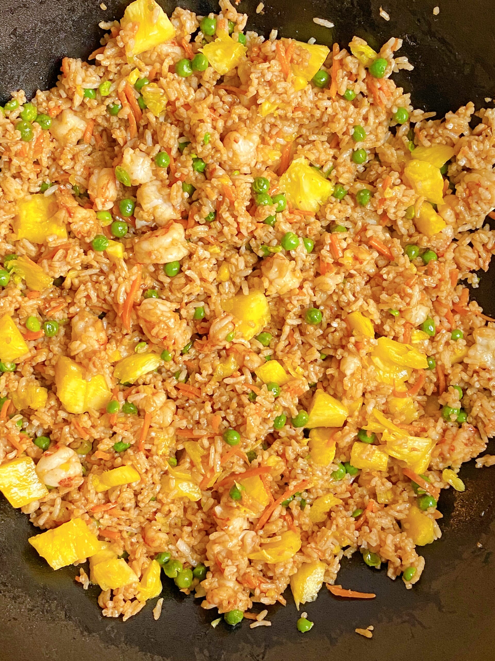 Close up view of Pineapple Shrimp Fried Rice in a wok