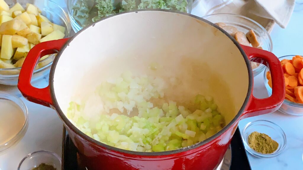 Overhead view of a red pot filled with chopped onions.