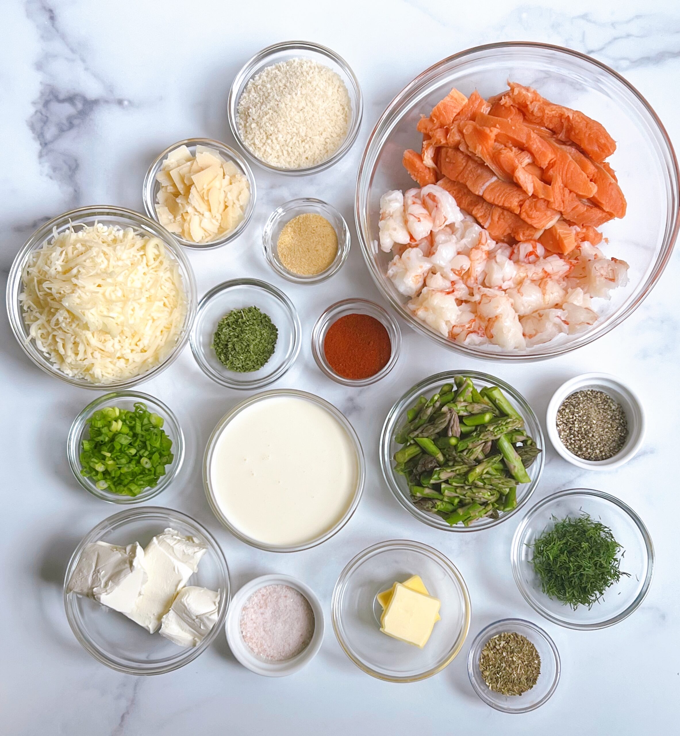 Overhead view of Shrimp and Salmon Seafood Casserole ingredients in individual glass bowls.