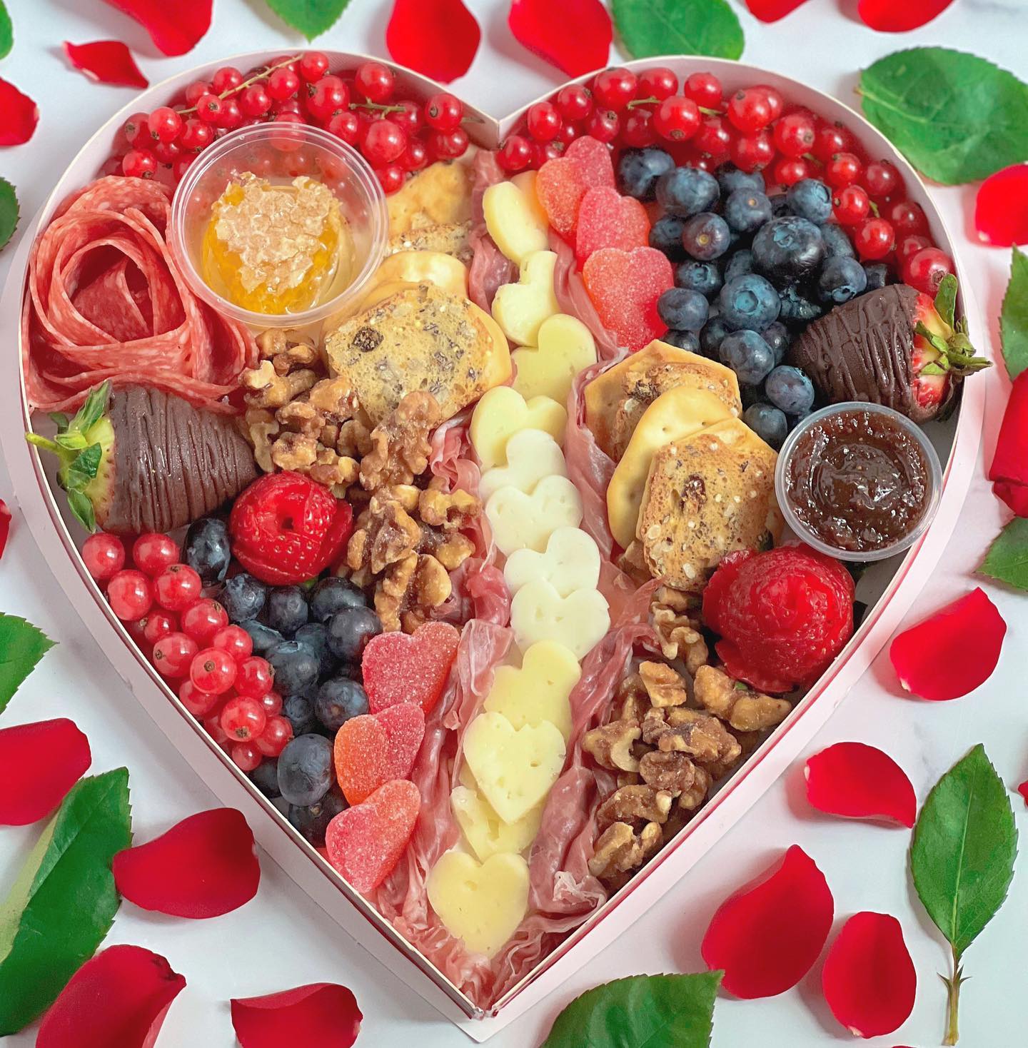 This heart ♥️ shaped box put the cute in charCUTErie. My Valentine’s Day boards made the perfect gift this year, this colorful and tasty spread is great for those who want sweet and savory. 🧀 🥜 
⠀⠀⠀⠀⠀⠀⠀⠀⠀
This box is filled with everything you'll need for an at-home date night, or pre/post night out. It's indulgent in every sense of the word with savory meats and cheeses to balance out the sweet fruits and nuts.
⠀⠀⠀⠀⠀⠀⠀⠀⠀
If you didn’t get a chance to order your Valentine’s Day box, no worries, you can always order your personalized grazing board anything. 😉 
°°°
#charcuterie #valentinesday #galentinesday #BADEatTribe #dcfoodblogger #dcfoodie #dmvfoodie #recipeideas #dmvfoodies #dceatss #cheeseboard #valentinestreats #blackgirlswhlblog #vdayfood