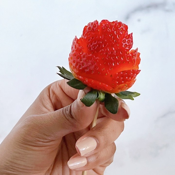 I loved making these Strawberry Roses 🌹 for my Valentine’s Day Charcuterie boxes! These editable roses made the perfect garnish and you can even make them for ice cream, cupcakes, fruit platters and dipping! See the below steps.⬇️

🍓🌹🍓
Step 1: Insert a strawberry on skewer stick. 

Step 2: Using a pairing knife, cut the first petal starting at the bottom of the strawberry. 

Step 3: Curl the petal back gently with the knife. 

Step 4: Cut a second row of petals - in between the bottom row. 

Step 5: Cut a small square to the top. 

Step 6: Repeat steps 2 & 3.
°°°
#strawberryroses #strawberrydessert #chacuterieboard #fruitplatter #fruitplate #sweetstrawberry #cheeseplatter #strawberries #strawberryrose #strawberrydecor #dcfoodblogger #dcfoodie #dcfoodies #blackgirlswhoblog #valentinesdayfood #valentinesdaydessert