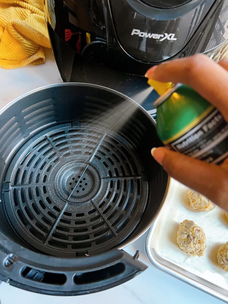 Spray the air fryer nonstick sprayer.